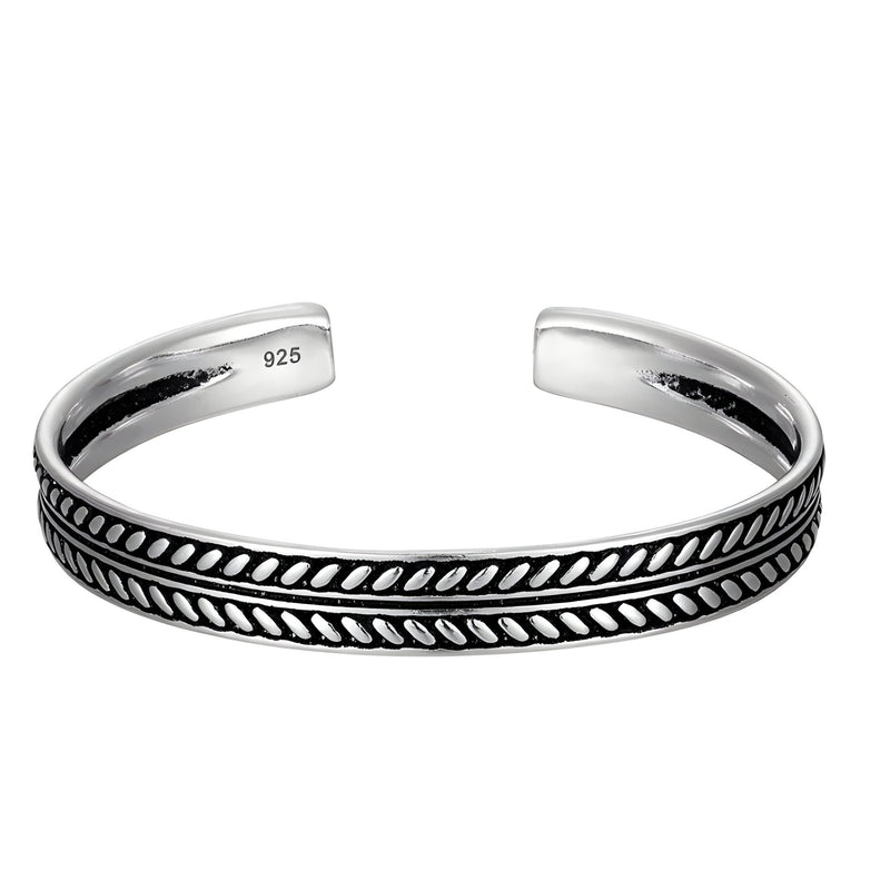 Bracelet tibétain ouvert en argent avec motif tressé noir et gravé 925 à l'intérieur.