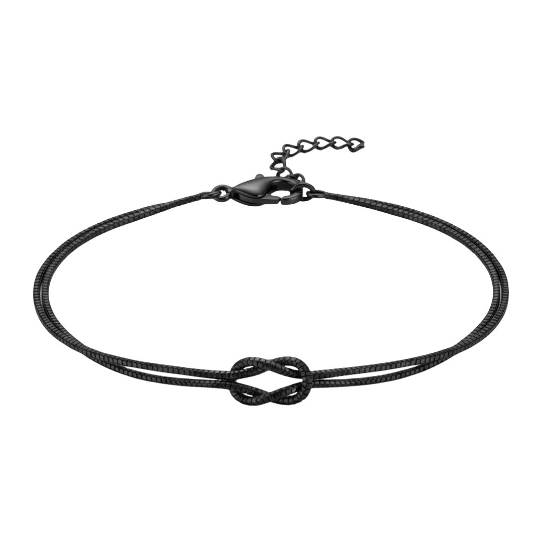 Bracelet fin en acier inoxydable noir avec nœud central et chaîne ajustable.
