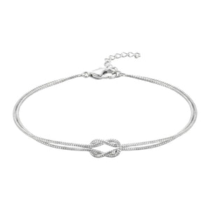Bracelet fin en acier inoxydable argenté avec nœud central élégant, chaîne double délicate ajustable.