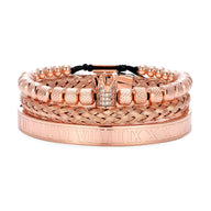 Trio de bracelets homme en acier inoxydable or rosé, motif couronne, détails texturés et gravés.