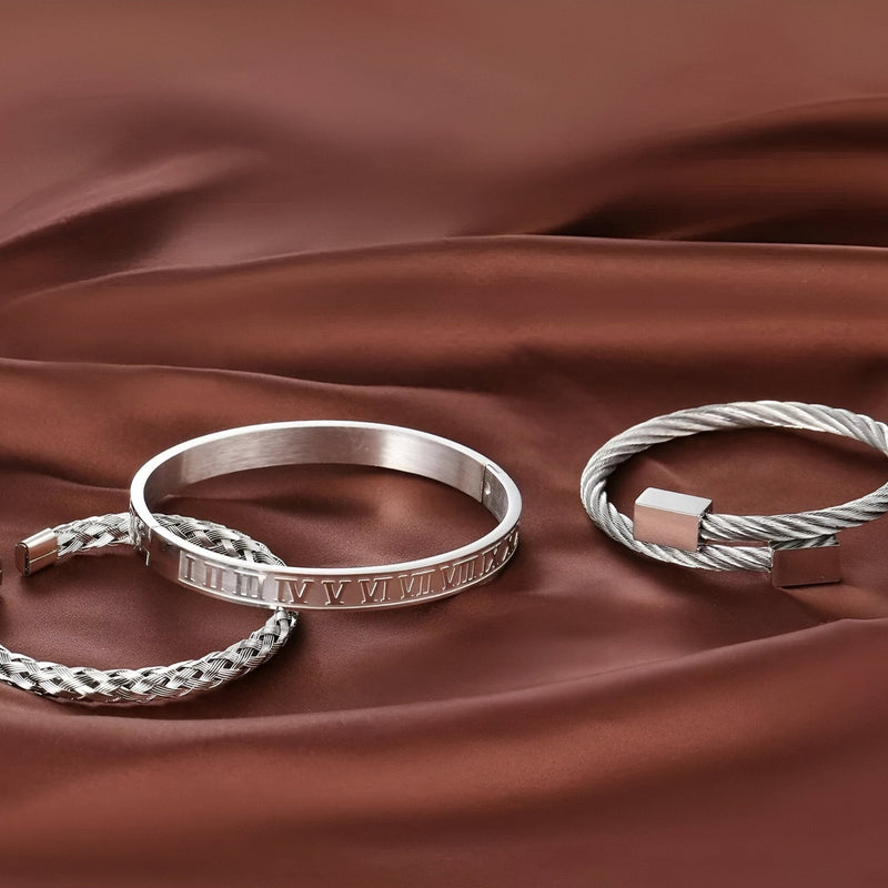 Trio de bracelets en acier inoxydable argenté, finition lisse, tressée et torsadée, style masculin élégant.