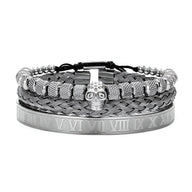 Trio de bracelets en acier inoxydable argenté avec têtes de mort et détails gravés, style masculin.