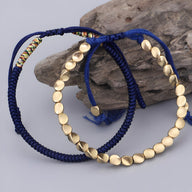 Trio de bracelets tibétains bleu en corde tressée et perles de cuivre doré.