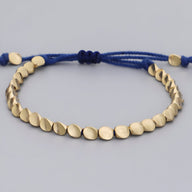 Trio de bracelets tibétains en cuivre doré et corde bleue ajustable pour femme.