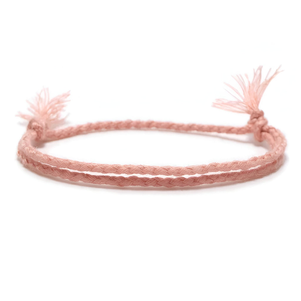Bracelet tibétain rose en coton tressé avec fermetures à nœud, style minimaliste homme.