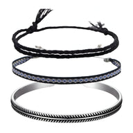 Trio de bracelets tibétains homme en coton noir et argent, motifs tressés et gravés.
