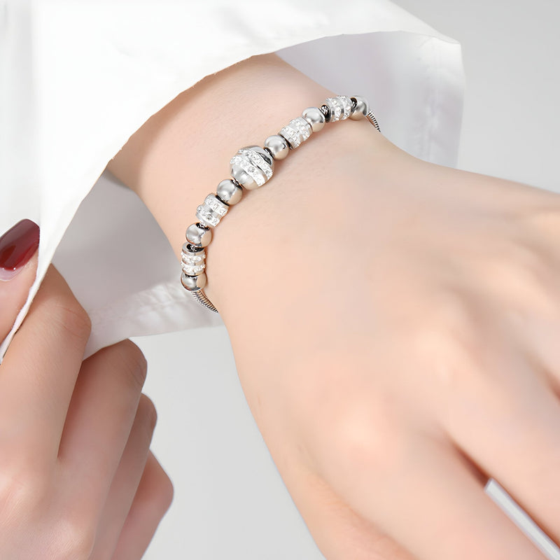 Bracelet femme en perles rondes en titane plaqué or avec cristaux étincelants, modèle Jennifer.