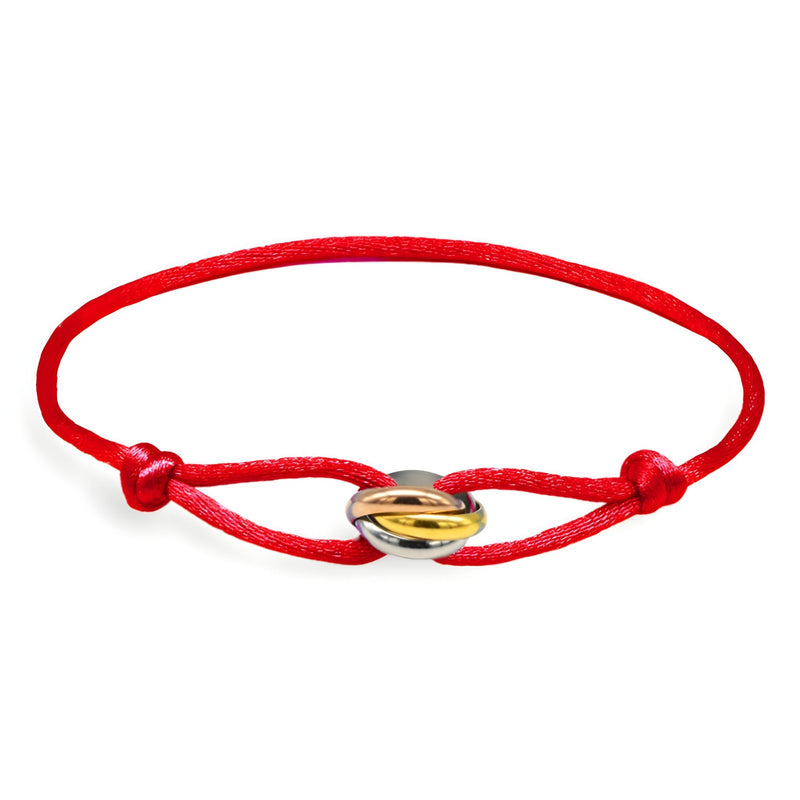 Bracelet cordon rouge avec cercles entrelacés dorés et argentés, ajustable pour femme.