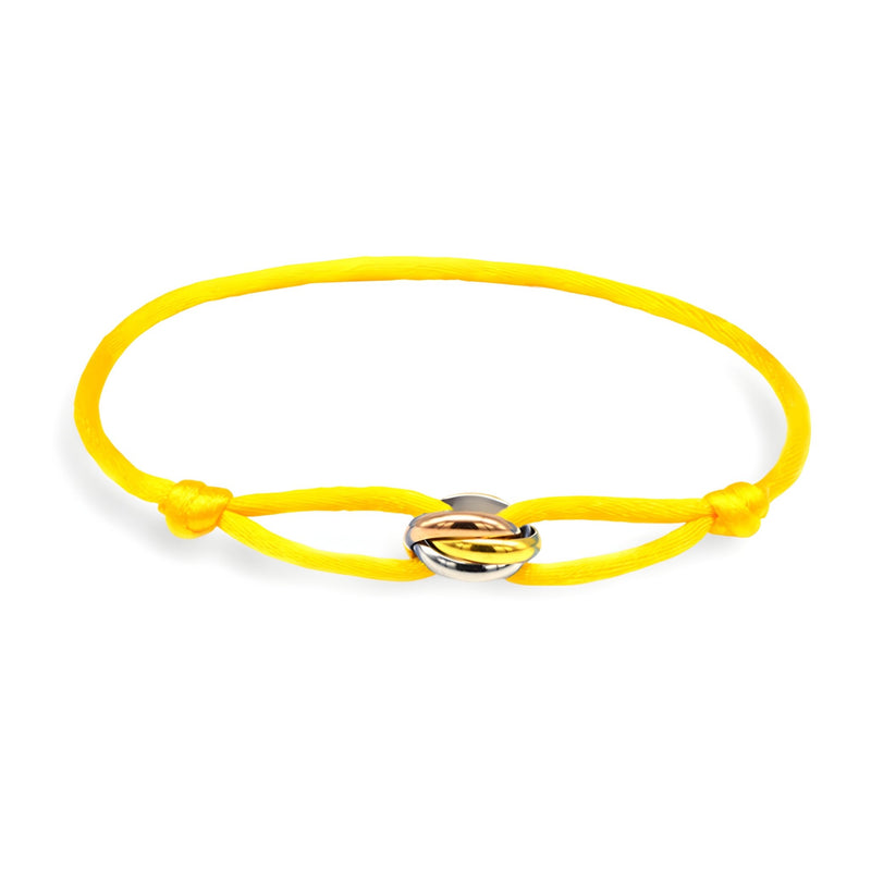 Bracelet cordon jaune avec cercle entrelacé en métal argenté et doré.