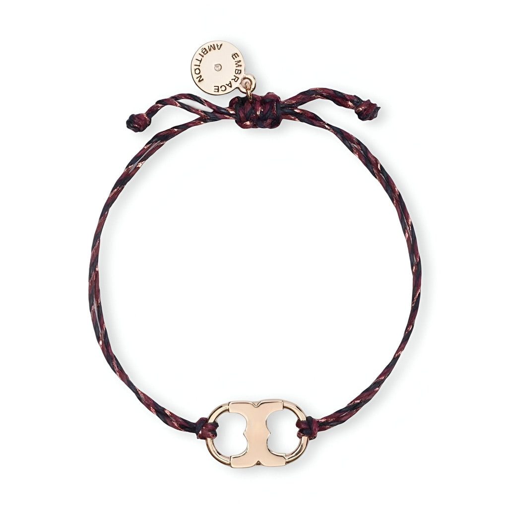 Bracelet cordon noir avec pendentif métal doré design minimaliste et petite médaille ronde.