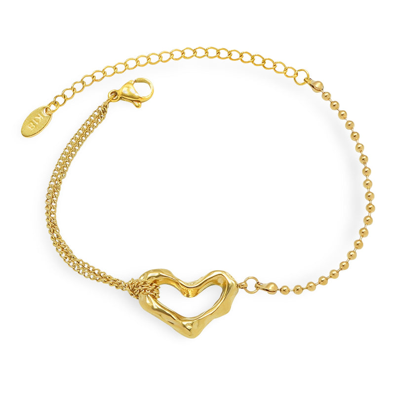 Bracelet fin en titane plaqué or 18 carats avec motif cœur ajouré et chaîne mixte maille boule et chaîne fine ajustable.