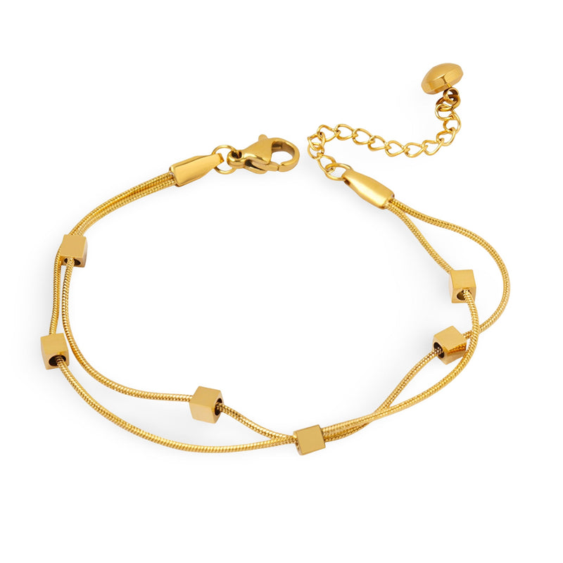 Bracelet double en titane plaqué or avec petits cubes géométriques et chaîne réglable.