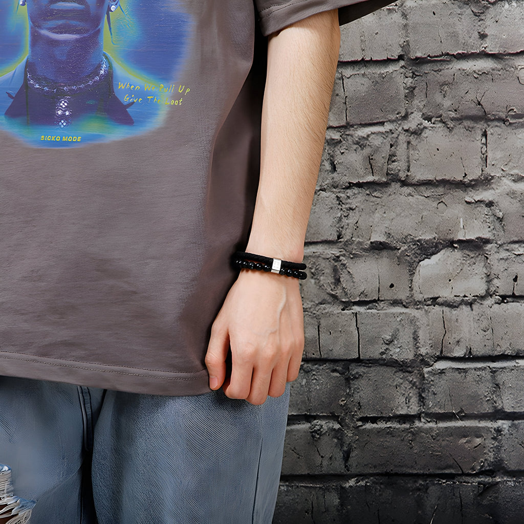 Bracelet homme en cuir noir avec perles en acier inoxydable et motif croix argentée.