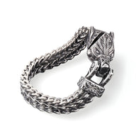 Bracelet en acier inoxydable argenté avec double chaîne tressée et fermoir sculpté tête de loup détaillée.