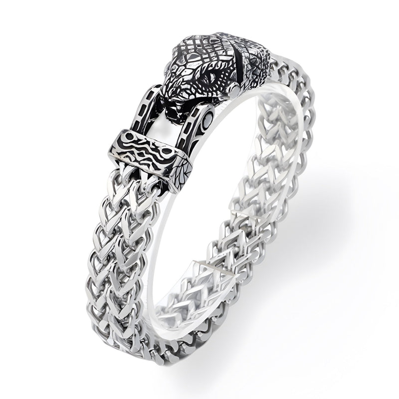 Bracelet en acier inoxydable argenté avec fermoir tête de serpent sculptée et maillons tressés détaillés.