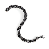 Bracelet homme en acier inoxydable noir, design torsadé, fermoir mousqueton argenté.