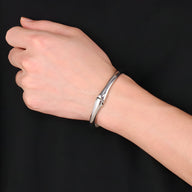 Bracelet en acier inoxydable argenté pour homme avec double tête de requin stylisée.