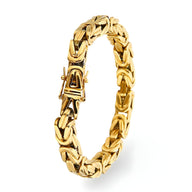 Bracelet homme en acier inoxydable doré avec maille cubaine épaisse et fermoir robuste.