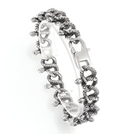 Bracelet homme en acier inoxydable argenté, motif entrelacs de serpents texturés, style audacieux.