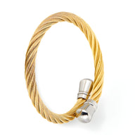 Bracelet jonc en acier inoxydable doré tressé avec fermoir argenté lisse.