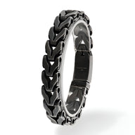Bracelet homme en acier inoxydable noir et argent avec maille spiga et fermoir sécurisé.