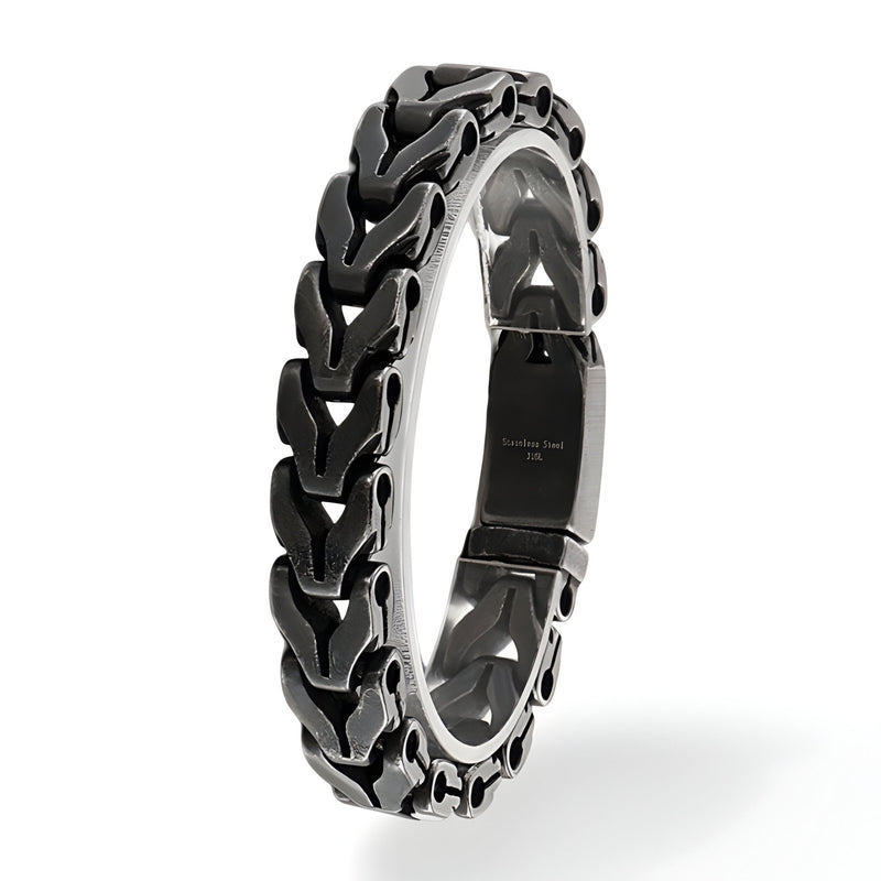 Bracelet homme en acier inoxydable noir et argent avec maille spiga et fermoir sécurisé.