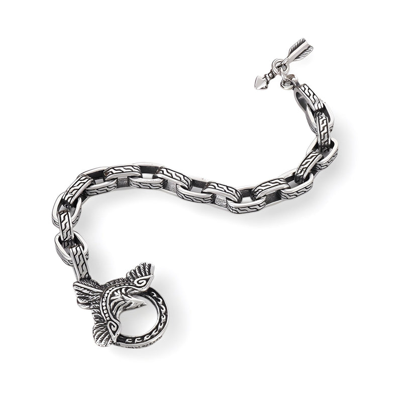 Bracelet en acier inoxydable argenté pour homme avec motif aigle stylisé et fermoir rond détaillé.