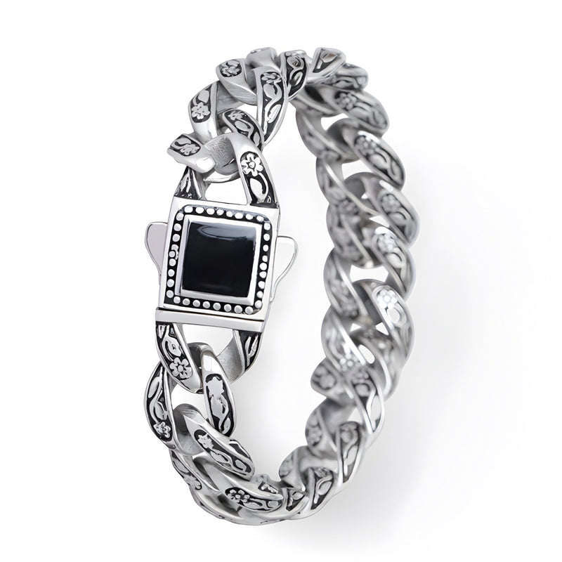 Bracelet homme en acier inoxydable argenté avec motif floral et pierre noire carrée centrale.