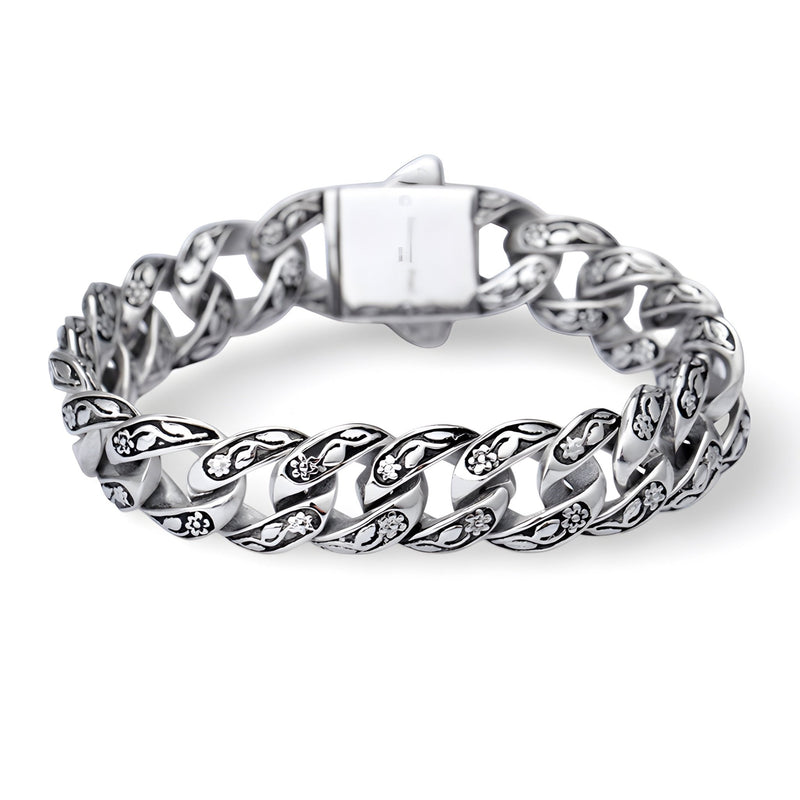 Bracelet en acier inoxydable argenté pour homme avec motif floral gravé sur chaque maille large.
