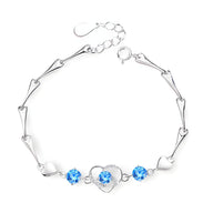 Bracelet en argent avec charms cœur et pierres bleues éclatantes, modèle Stacy.