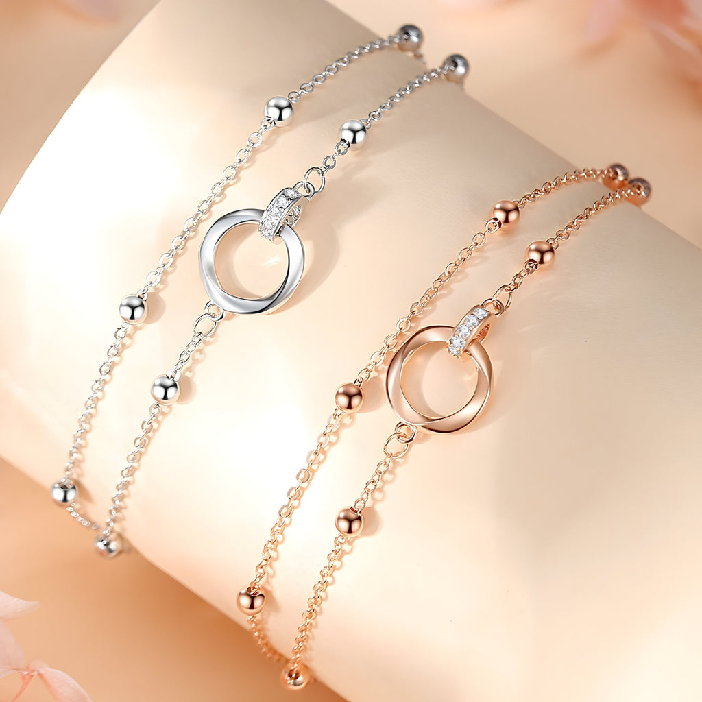 Bracelet femme en argent sterling avec anneau central rond et petites boules, version argent et argent rosé.