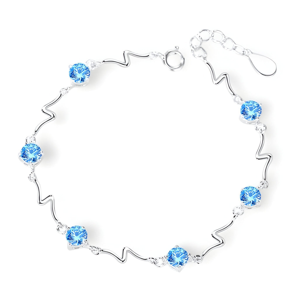 Bracelet en argent sterling avec perles bleues et maillons ondulés, style océanique.