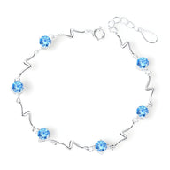 Bracelet en argent sterling avec perles bleues et maillons ondulés, style océanique.