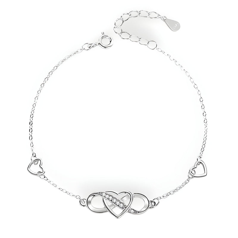 Bracelet en argent sterling avec charm infini et cœur ajouré, deux petits cœurs sur la chaîne.