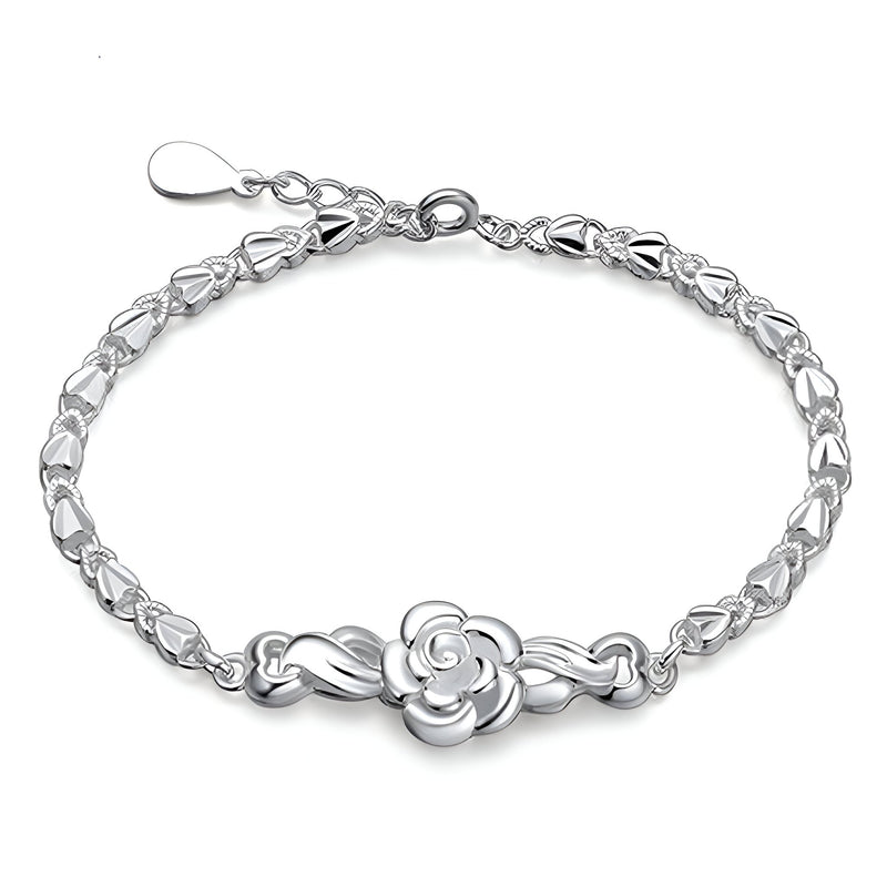 Bracelet argent sterling pour femme avec charme floral délicat au centre, fermeture ajustable.