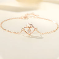 Bracelet en argent sterling or rose avec pendentif coeur ajouré et petit diamant central.