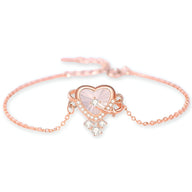 Bracelet réglable en argent sterling or rosé avec pendentif cœur orné de petites pierres scintillantes.