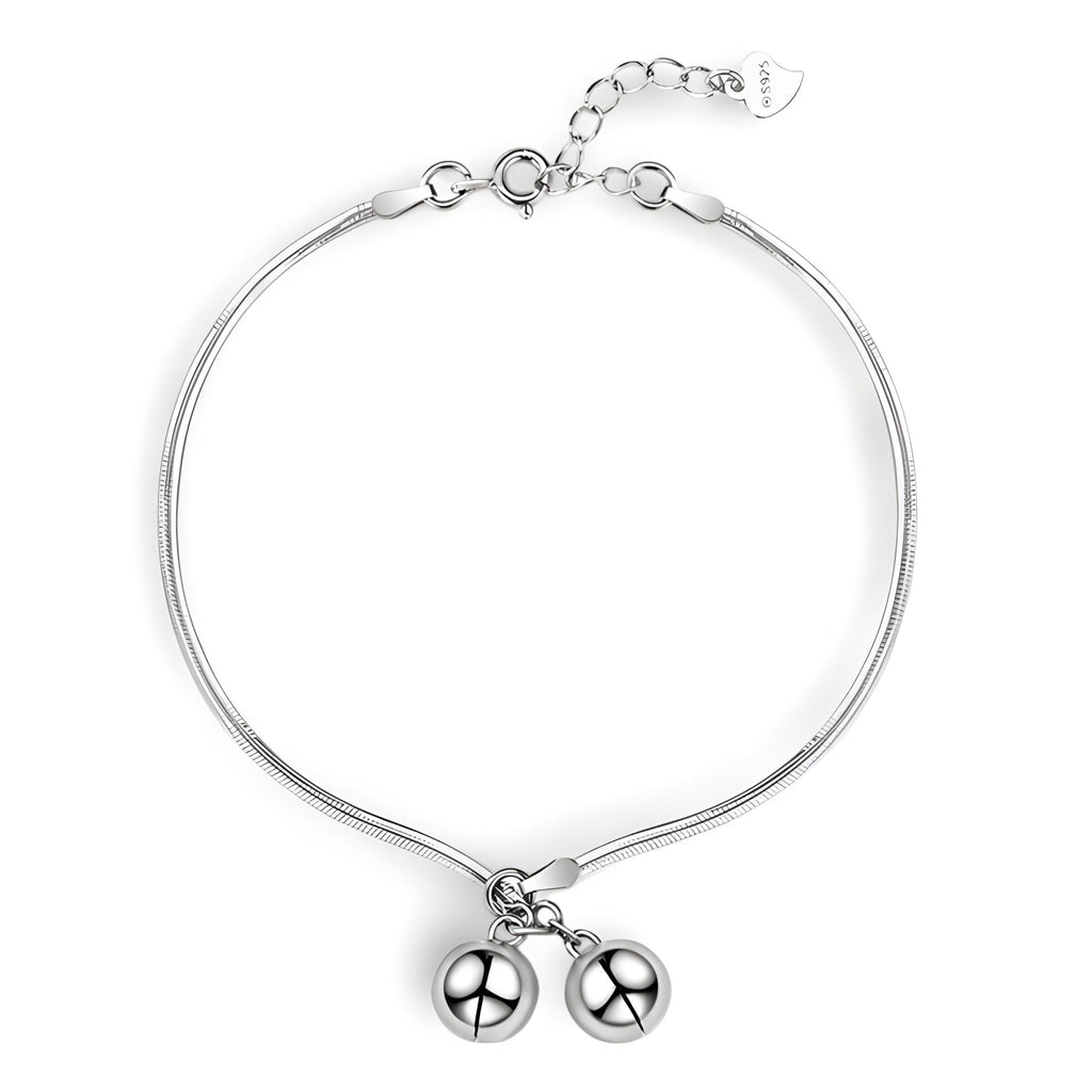 Bracelet fin en argent sterling avec deux perles suspendues et chaîne ajustable.