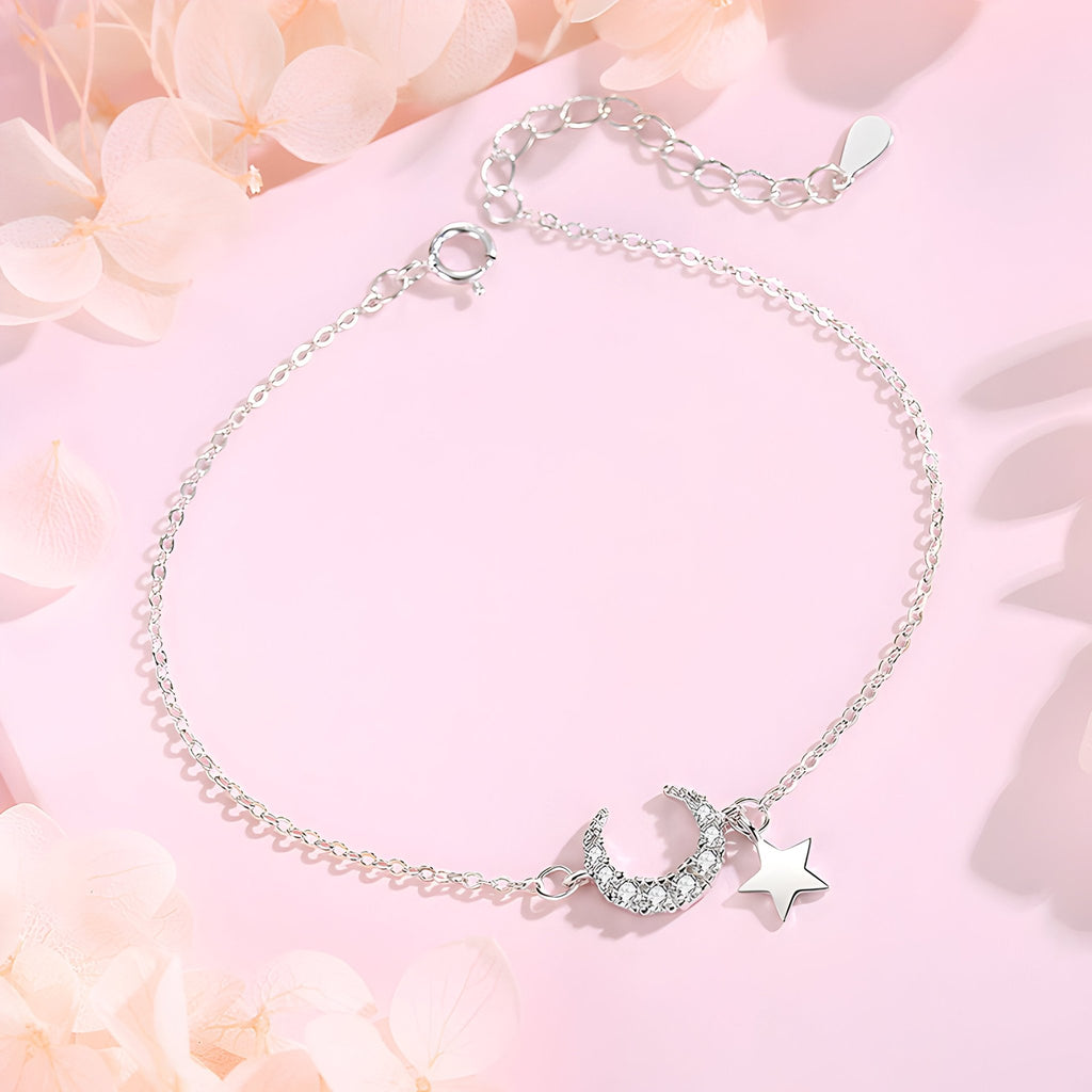 Bracelet en argent sterling fin avec pendentifs lune ciselée et étoile polie sur chaîne délicate.