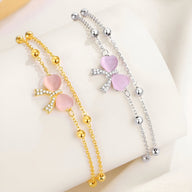 Bracelet femme en argent sterling avec pendentif noeud ruban et cœur rose pâle, chaîne à billes fines.