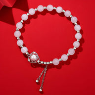 Bracelet en argent sterling avec perles rondes rose pâle et pierres de jade, fermoir à boule et chaîne ajustable.