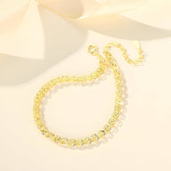 Bracelet torsadé en argent sterling finition dorée avec fermoir mousqueton et chaîne d'extension.