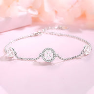 Bracelet en argent sterling avec trois motifs trèfle à quatre feuilles et chaîne fine.