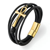 Bracelet multi-rangs en cuir noir avec motif croix doré et fermoir magnétique doré.