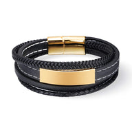 Bracelet multi-rangs en cuir noir avec plaque et fermoir métalliques dorés, couture blanche visible.