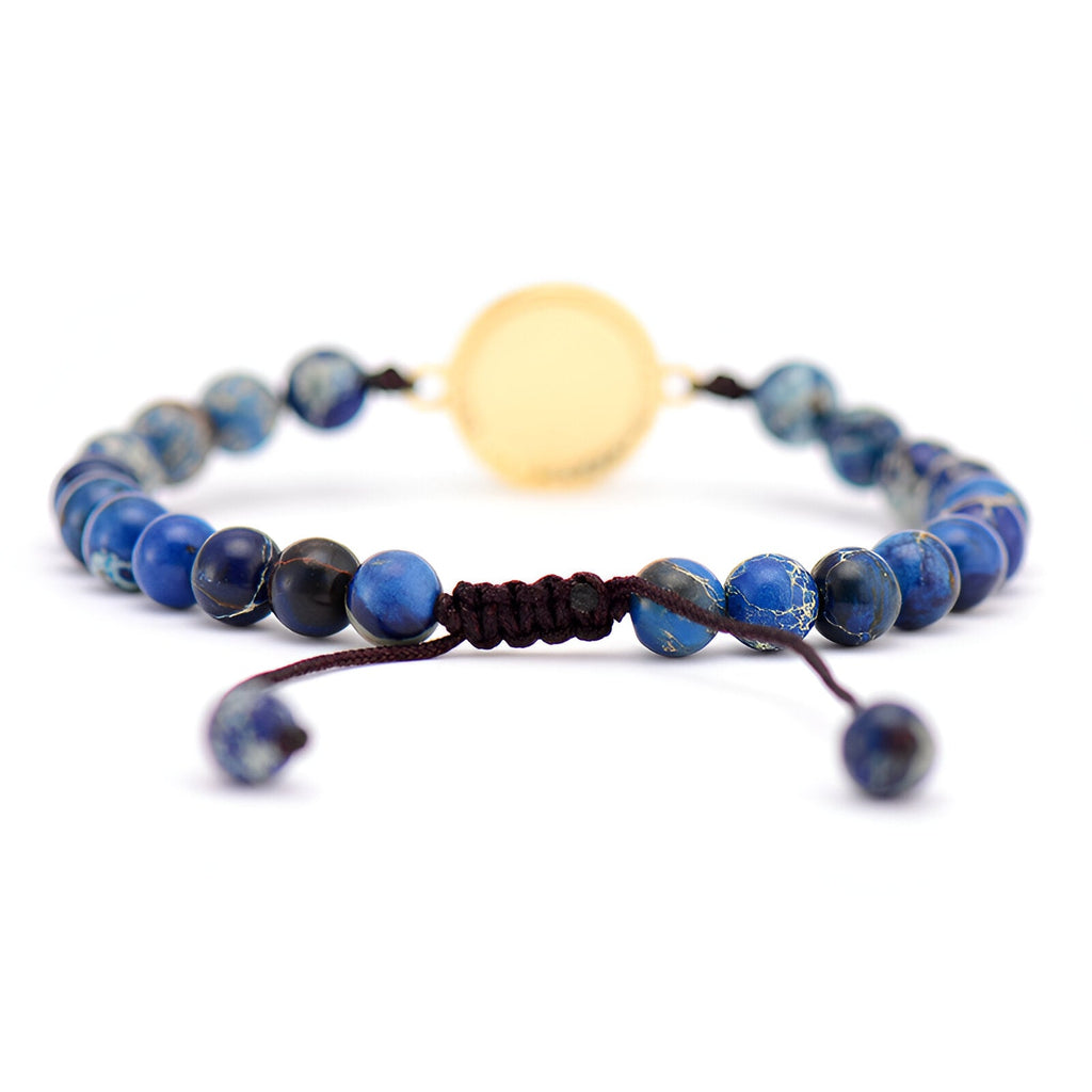 Bracelet bleu en pierres de jaspe rondes avec opale centrale et cordon ajustable noir.