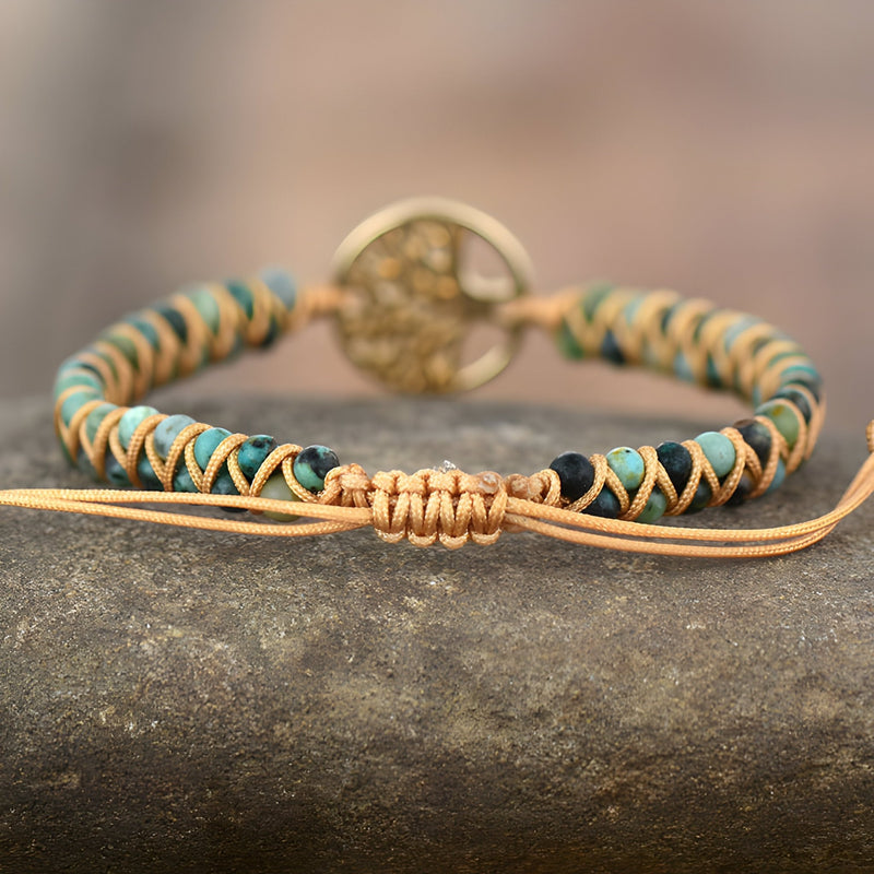 Bracelet en pierres de jaspe marron et beige avec pendentif arbre de vie doré et cordon ajustable en cuir.