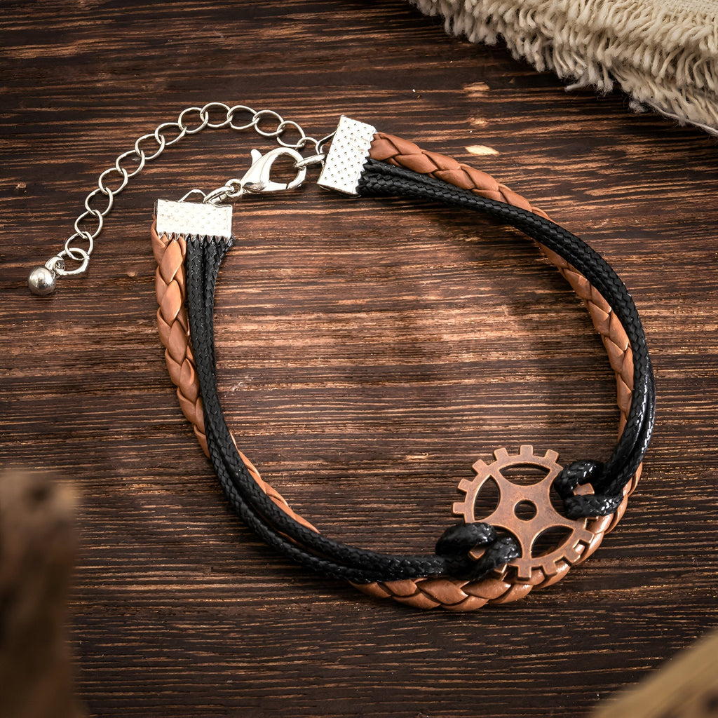 Bracelet multi-rangs homme cuir marron et noir avec gouvernail en métal coulé vieilli.