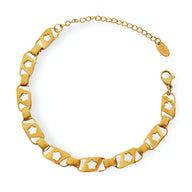 Bracelet en titane plaqué or 18 carats avec maillons hexagonaux et étoiles creuses, fermoir mousqueton.