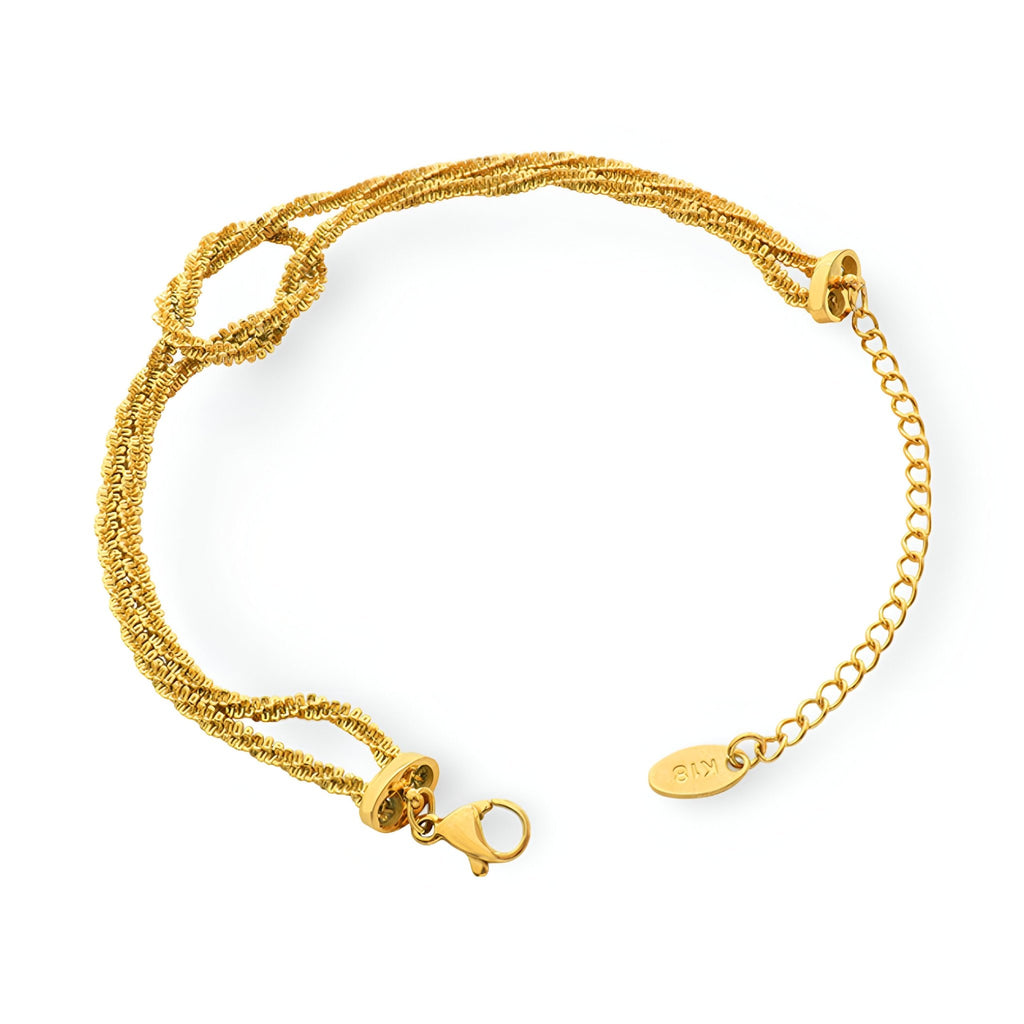 Bracelet en titane plaqué or tressé avec fermeture à mousqueton et chaîne réglable.